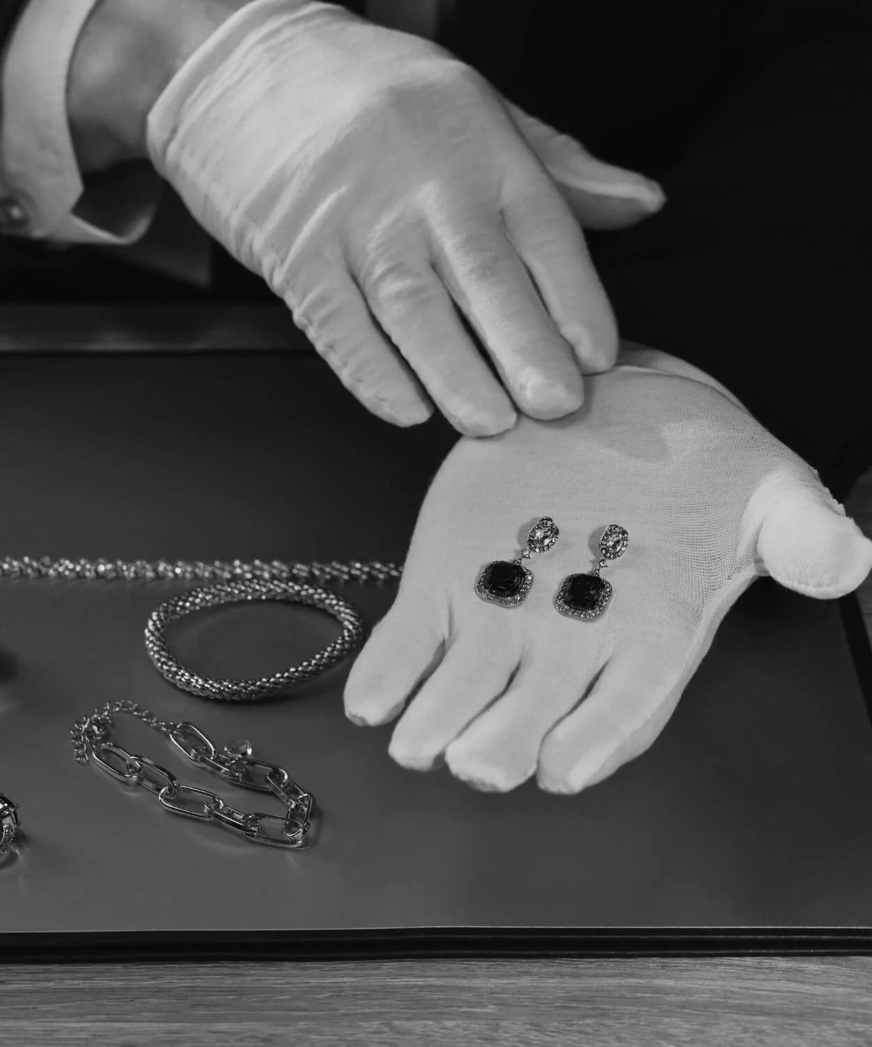 Diamore Luraya jeweler inspecting lab grown diamond earrings at handcrafting workshop in the USA