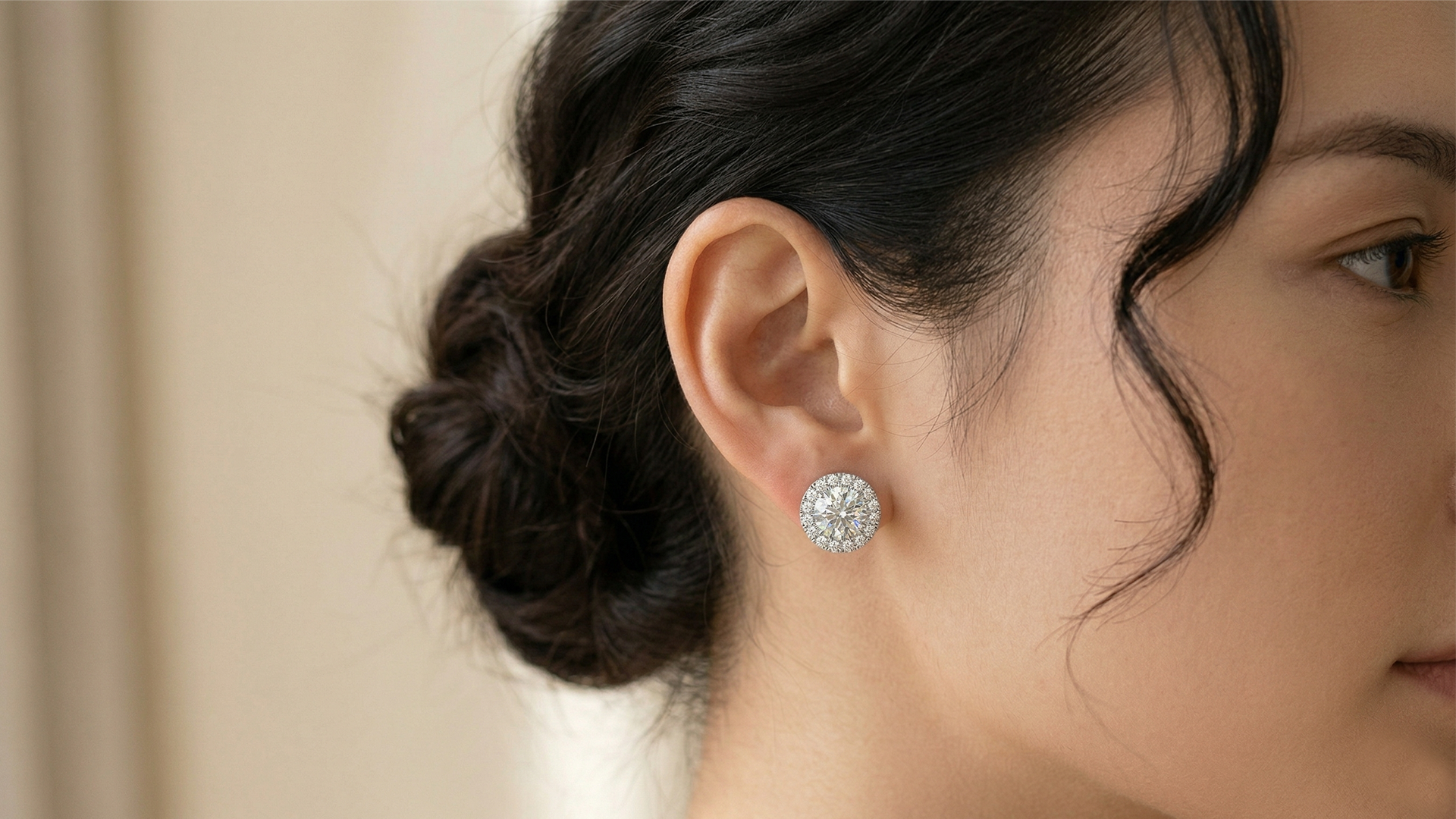 Woman wearing Diamore Luraya’s Round Halo stud earrings sparkling in natural light