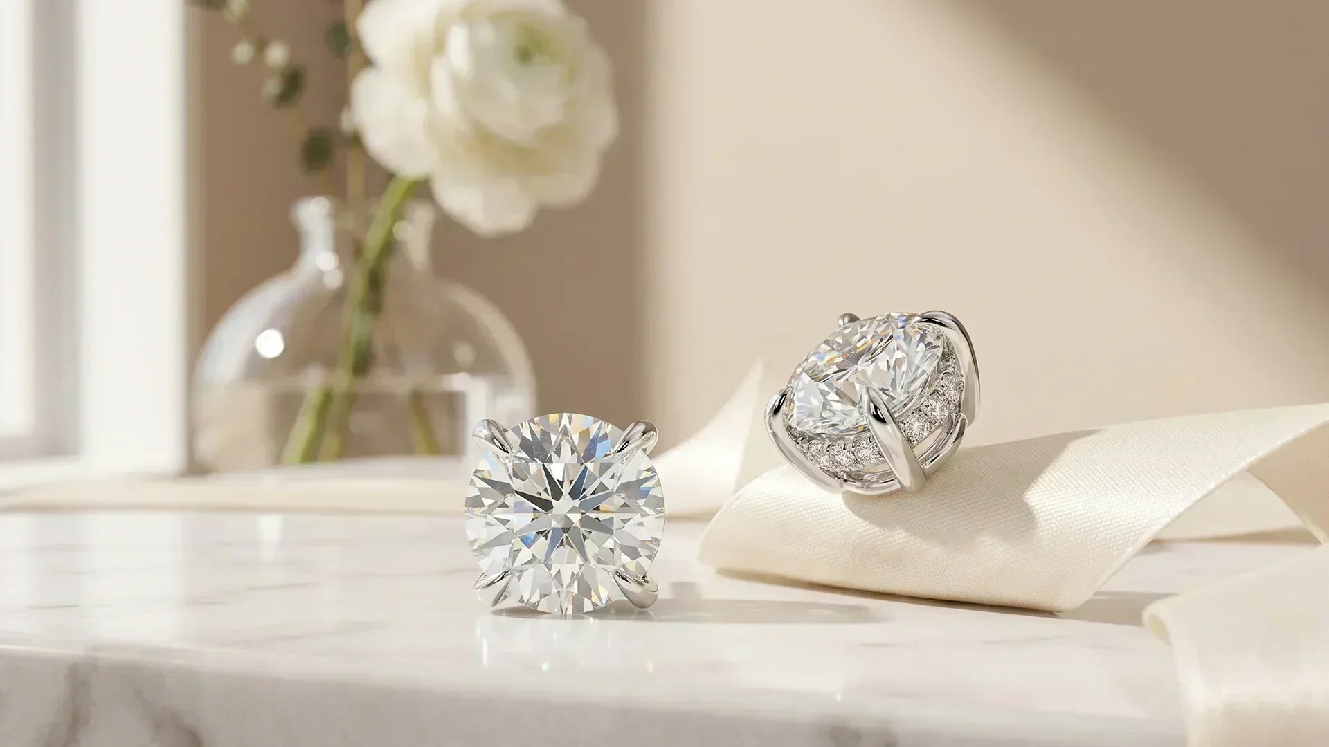 Round hidden halo lab-grown diamond studs on white marble