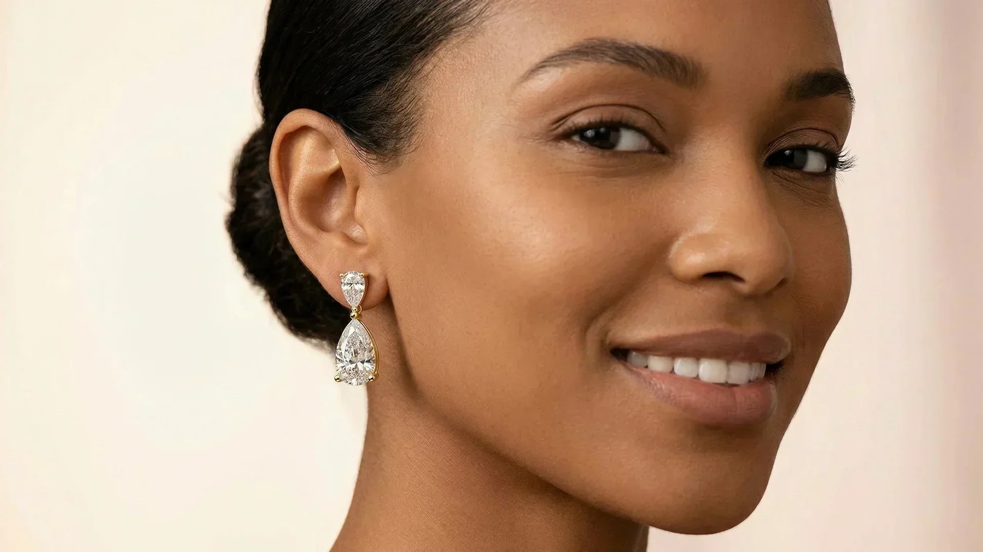 Pear drop earrings on heart-shaped face model