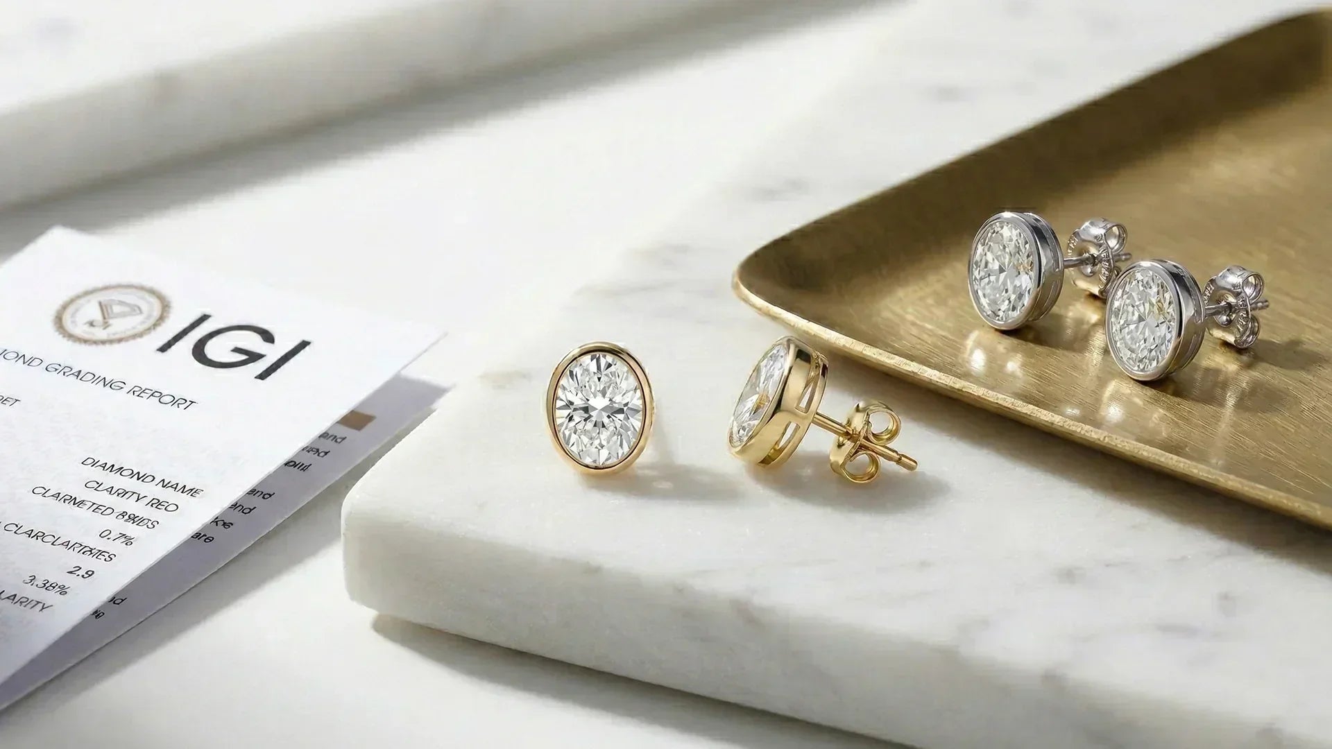 Oval bezel lab-grown diamond studs with IGI grading report 