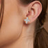 White gold lab grown diamond marquise floral earrings worn on woman's ear close-up model shot showing sparkling four petal design