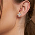 Rose gold lab grown diamond marquise floral earrings worn on woman's ear close-up model shot showing sparkling four petal design