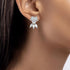 White gold diamond bow earrings worn on ear, close-up of sparkling pear cluster on model, hypoallergenic white gold diamond jewelry photoshoot