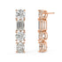Rose gold diamond linear studs worn on ear, sparkling round emerald oval cluster close-up, stylish rose gold vertical diamond earrings for women