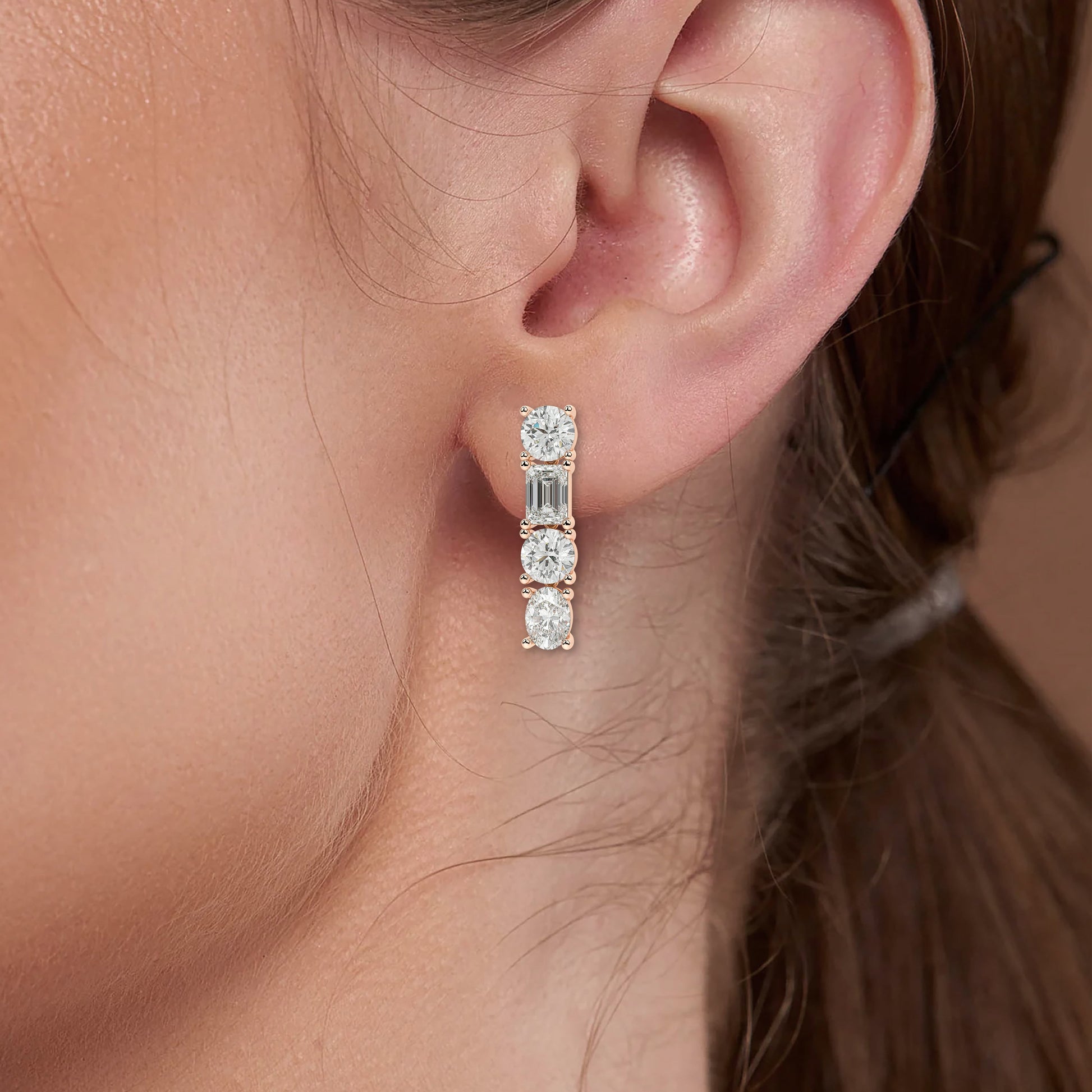 Rose gold ladder diamond earrings worn on ear close-up, elegant mixed cut vertical bar design, trendy rose gold lab diamond jewelry