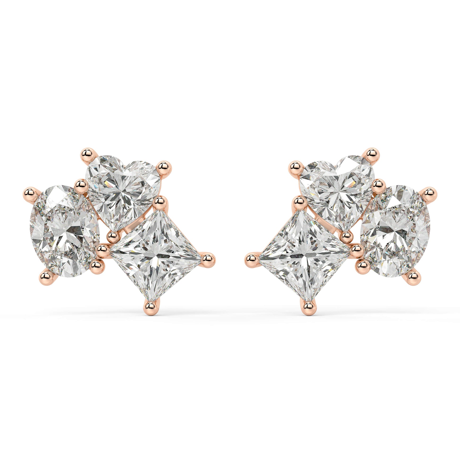 Angled shot of rose gold lab-grown diamond cluster drop earrings with oval center and pear side brilliants, pair illustrated, trendy luxury diamond earrings
