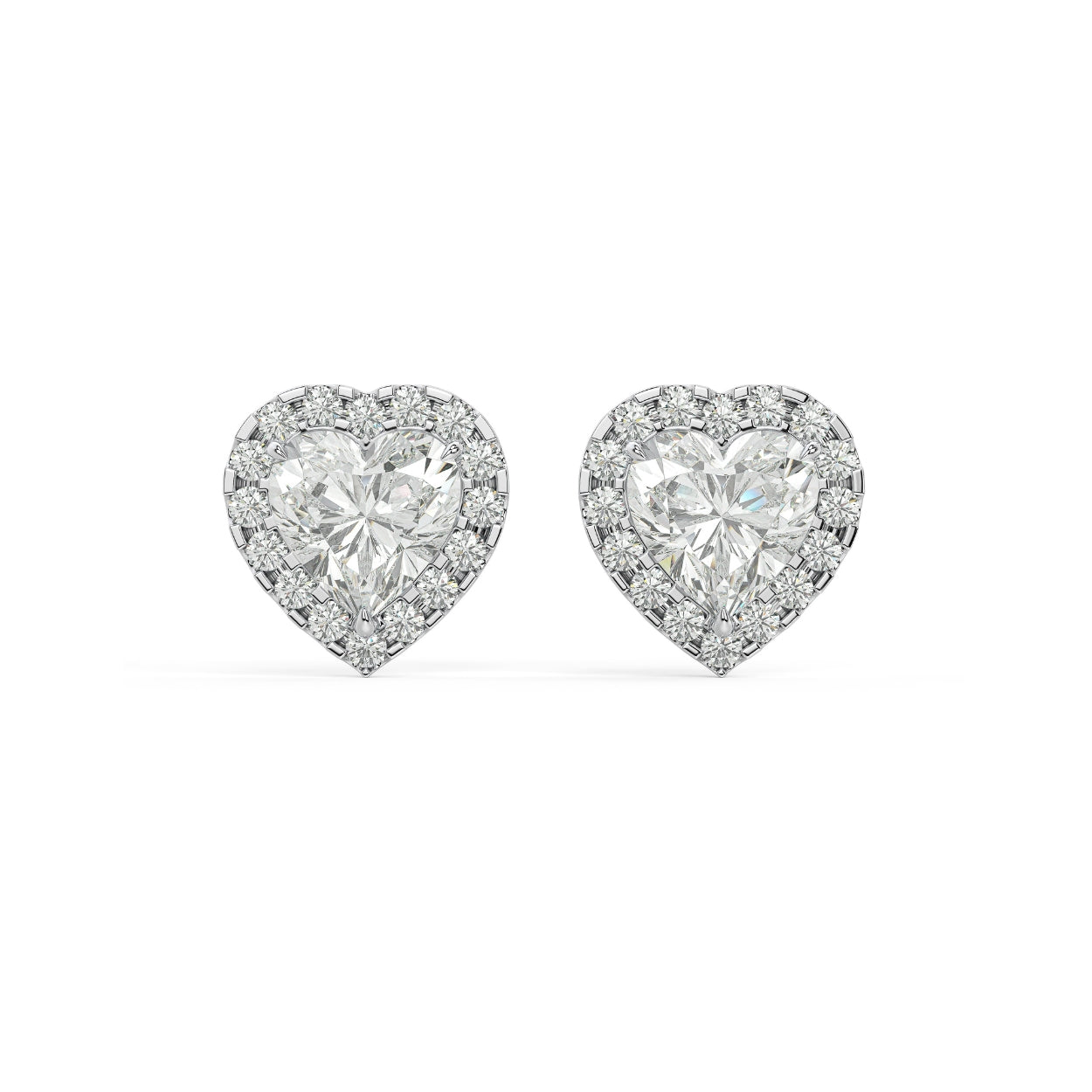 Pair of Heart Halo lab grown diamond earrings in white gold featuring heart cut elevated by halo for soft bursts of light evoking deep feelings on white background.