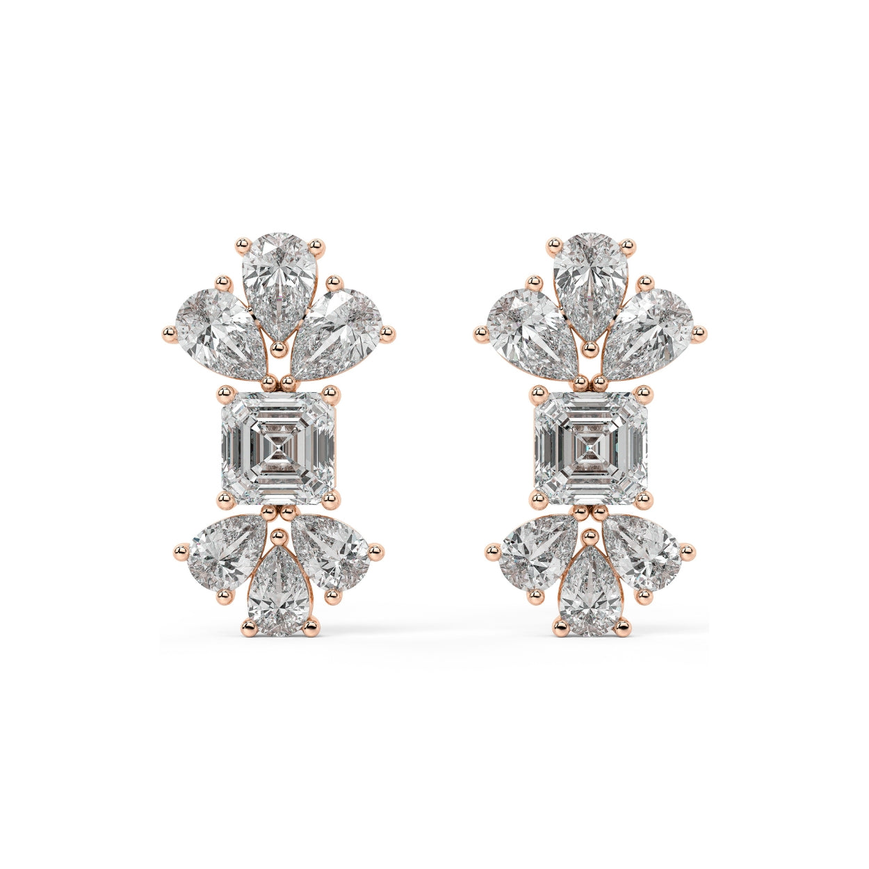 Angled view of rose gold lab-grown diamond multi-stone earrings with emerald focal and pear accents, sparkling drop design, trendy diamond jewelry