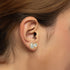 Model wearing Sorelle Studs lab grown double diamond earrings in yellow gold on ear, showcasing the sleek bezel that doubles sparkle without hassle for everyday modern edge and worry-free wear.