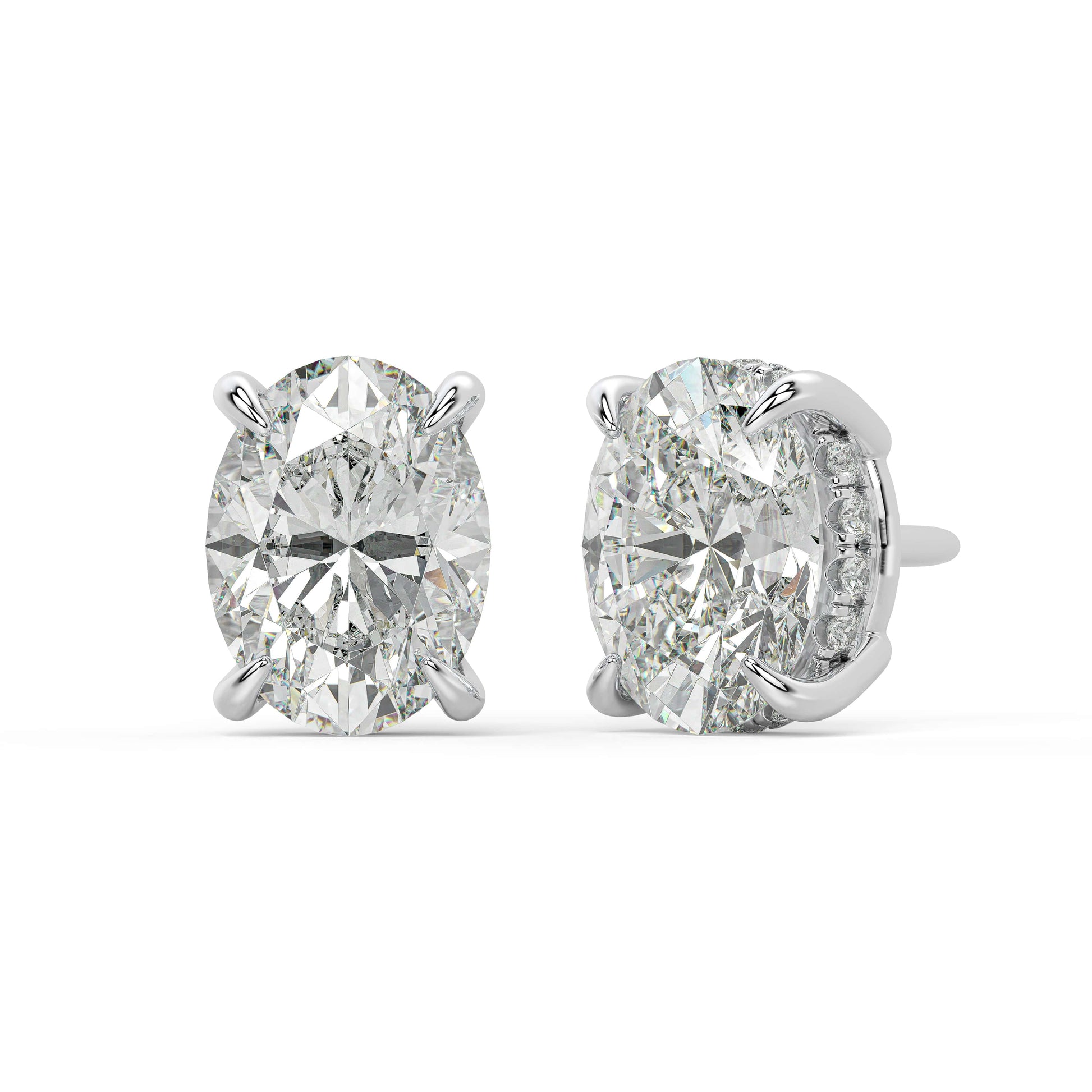 Angled front of white gold Oval Hidden Halo earrings showing straightforward four prong and hidden diamonds for earth friendly methods with elite VS plus clarity.