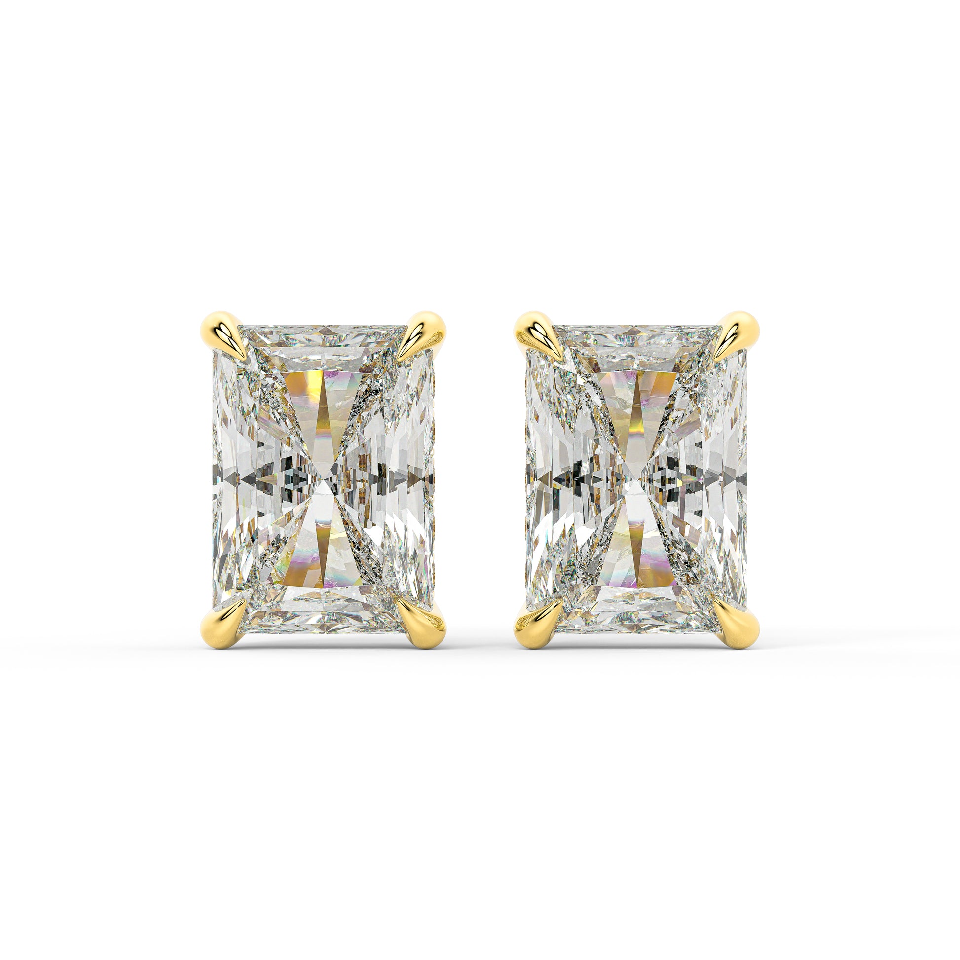 Pair of yellow gold stud earrings showcasing elongated radiant diamonds in a smooth bezel. A hidden Pavé halo rests beneath the main stone to catch light from every direction.