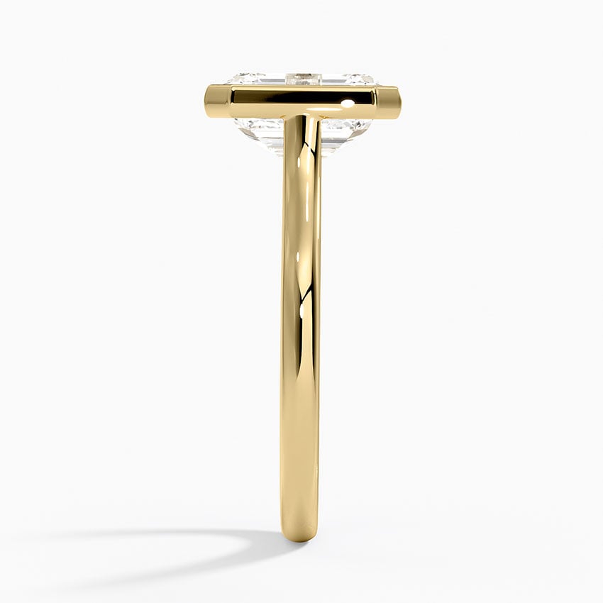 Bezel solitaire engagement ring setting in 14K yellow gold, profile view