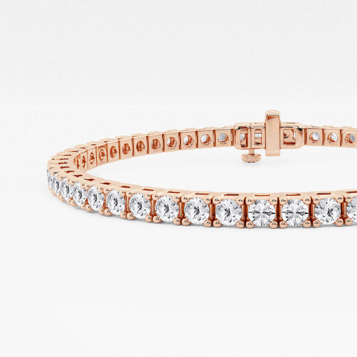Close-up of four-prong settings and box clasp, 14K rose gold tennis bracelet