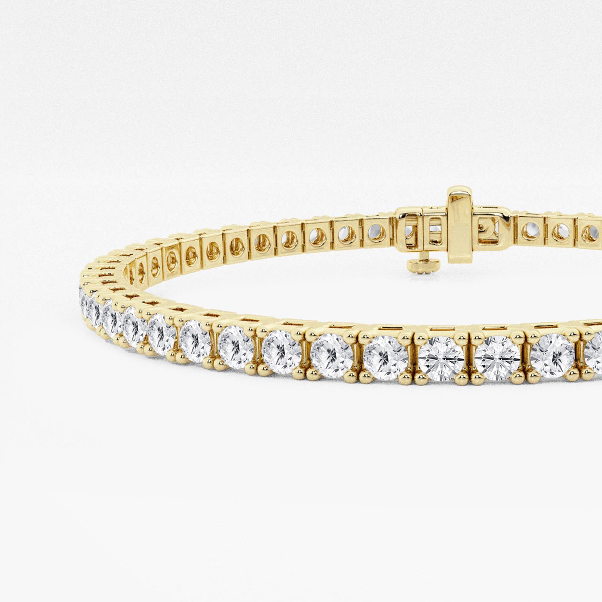 Close-up of four-prong settings and box clasp, 14K yellow gold tennis bracelet
