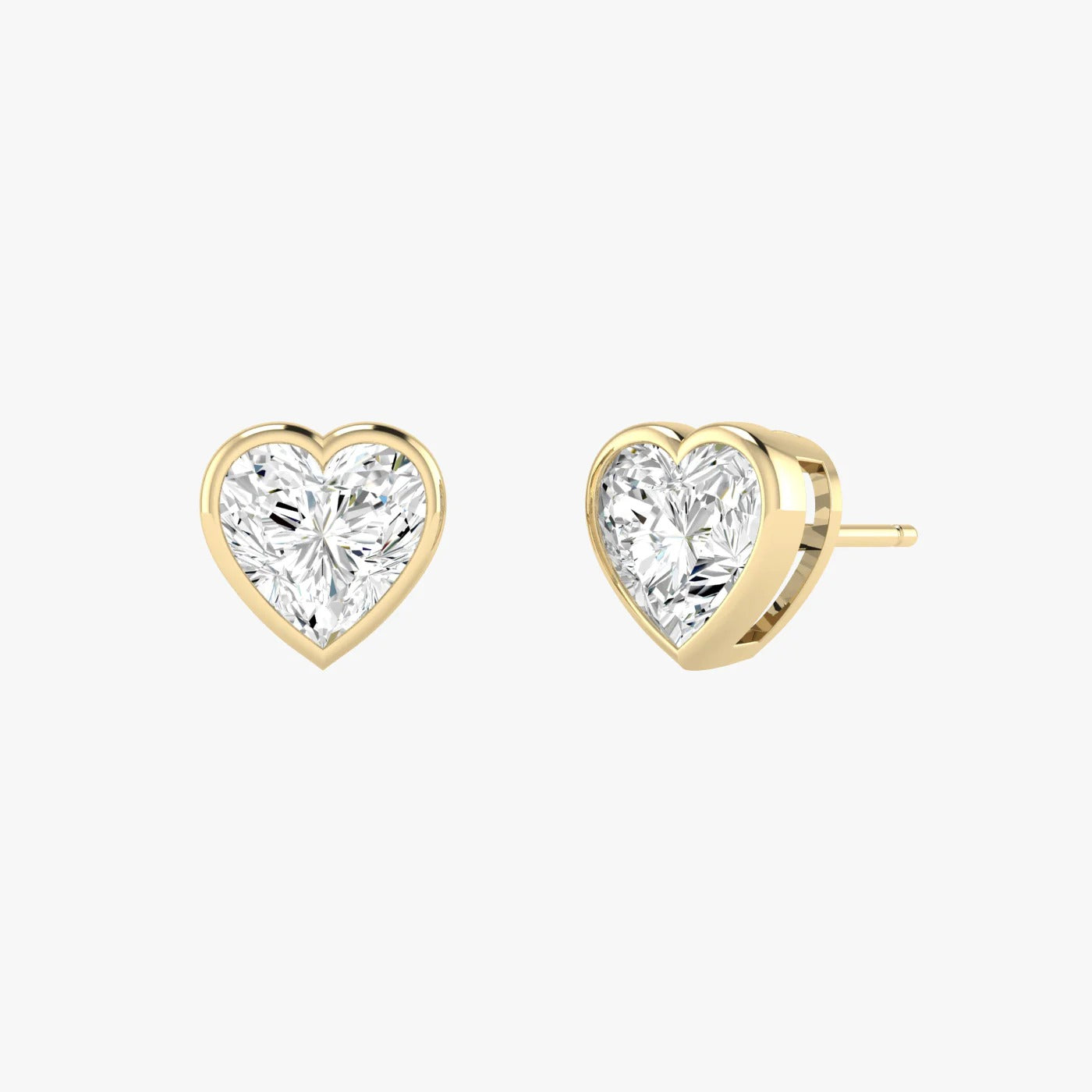 Angled view of yellow gold lab-grown diamond heart earrings featuring cleft-top heart center stone, pair shown, high-end minimalist luxury jewelry
