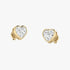 Model wearing yellow gold lab-grown diamond heart stud earrings on ear, side profile view, sparkling heart-shaped diamond design, elegant romantic studs