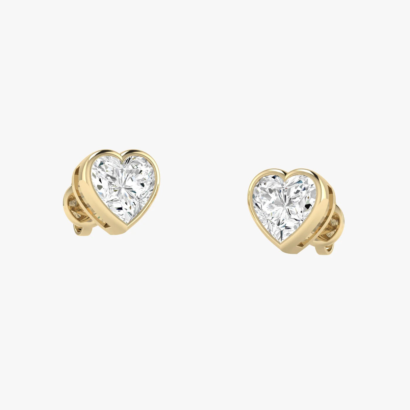 Model wearing yellow gold lab-grown diamond heart stud earrings on ear, side profile view, sparkling heart-shaped diamond design, elegant romantic studs