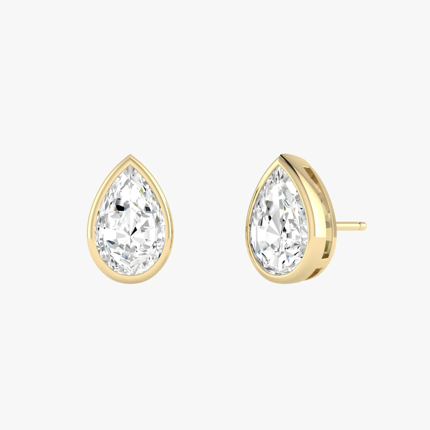Angled view of yellow gold lab-grown diamond pear earrings featuring rounded-top pointed pear center stone, pair shown, high-end minimalist luxury jewelry