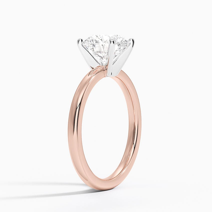 Solitaire engagement ring setting in 14K rose gold, angled side view