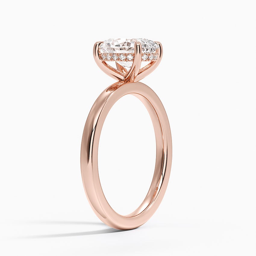 Solitaire engagement ring setting in 14K rose gold, angled side view